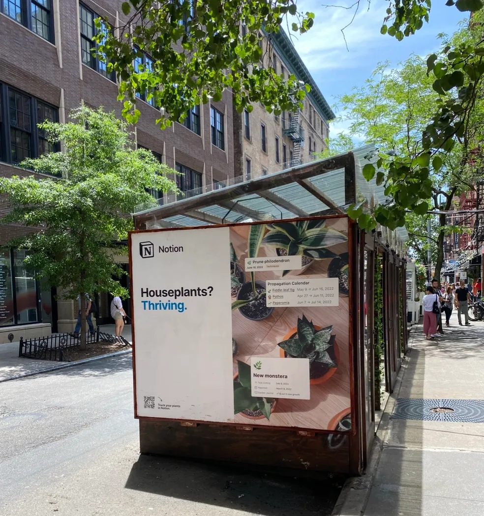 Wooden sidewalk dining structure wrapped in a software brand campaign