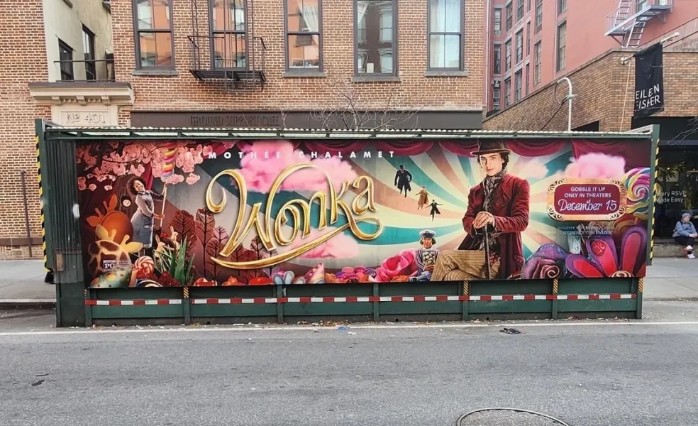Sidewalk dining structure wrapped in a feature film campaign outside a cafe